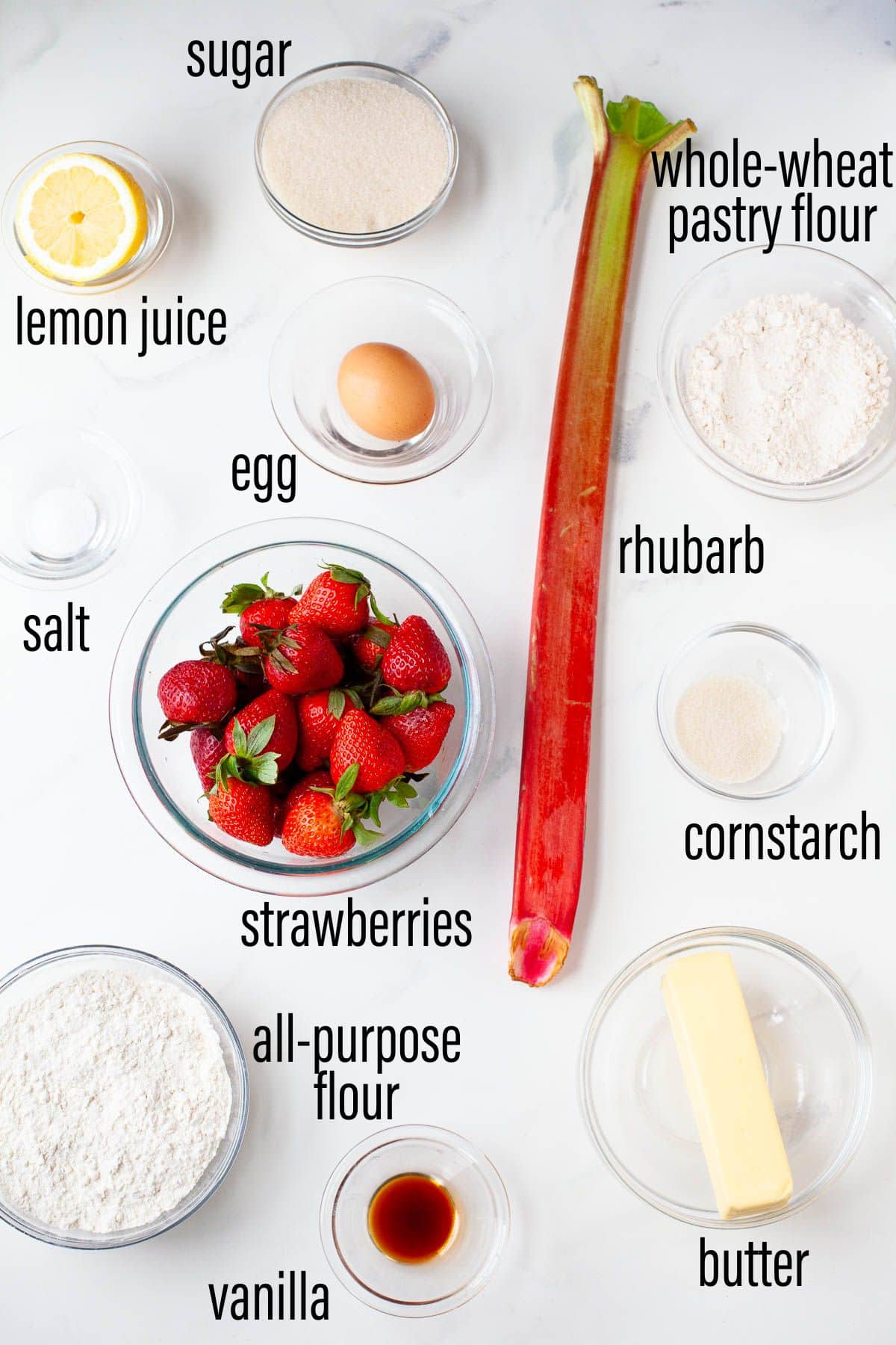 graphic of ingredients for strawberry rhubarb galette on marble surface with black text overlay.